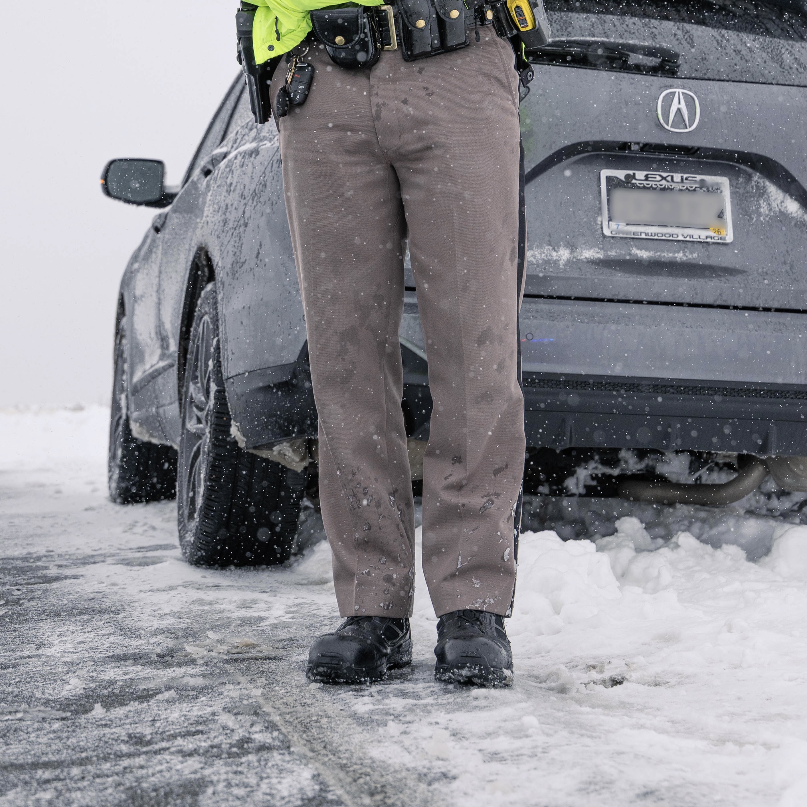 trooper in snow standing next to white line on road