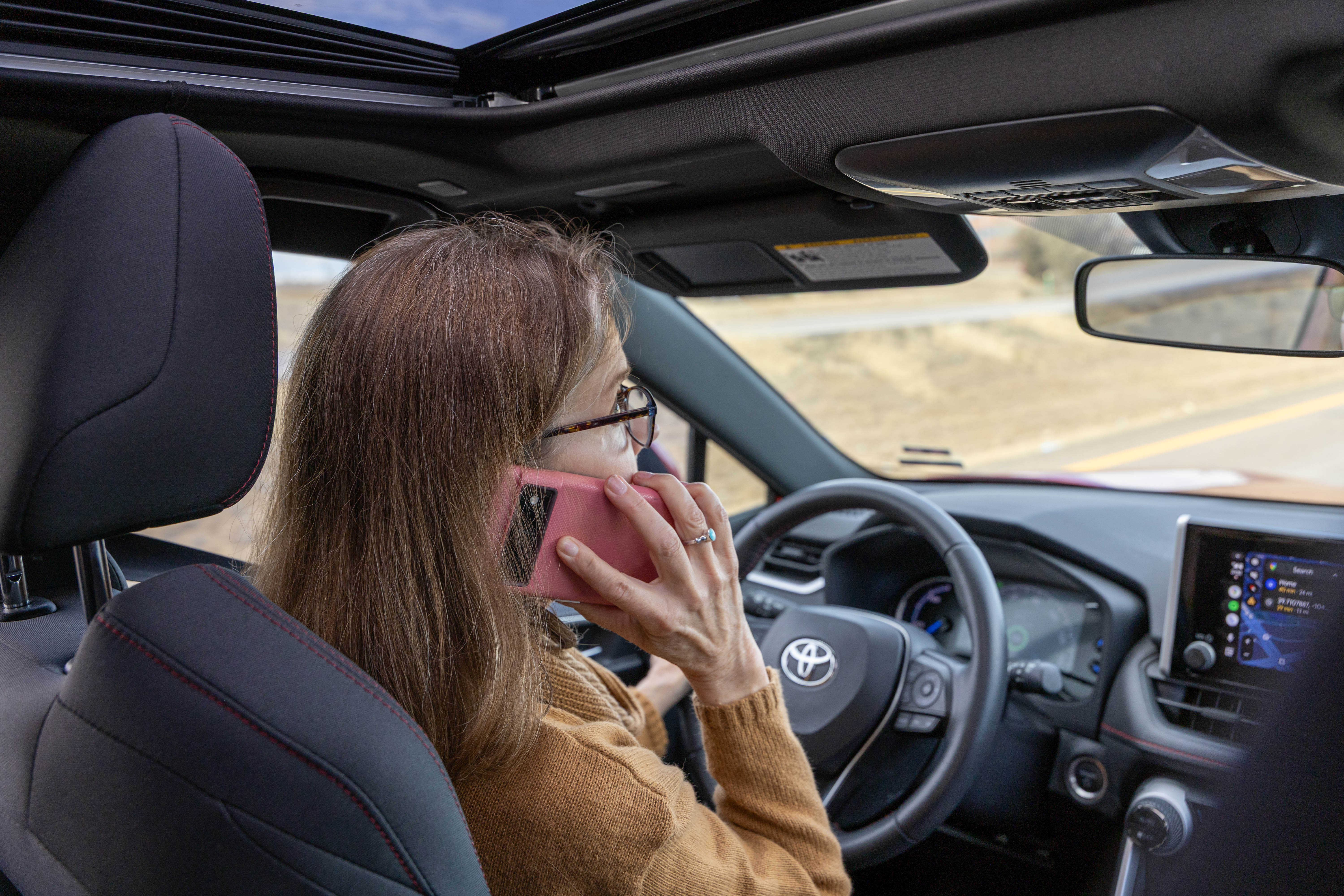 person talking on phone while driving