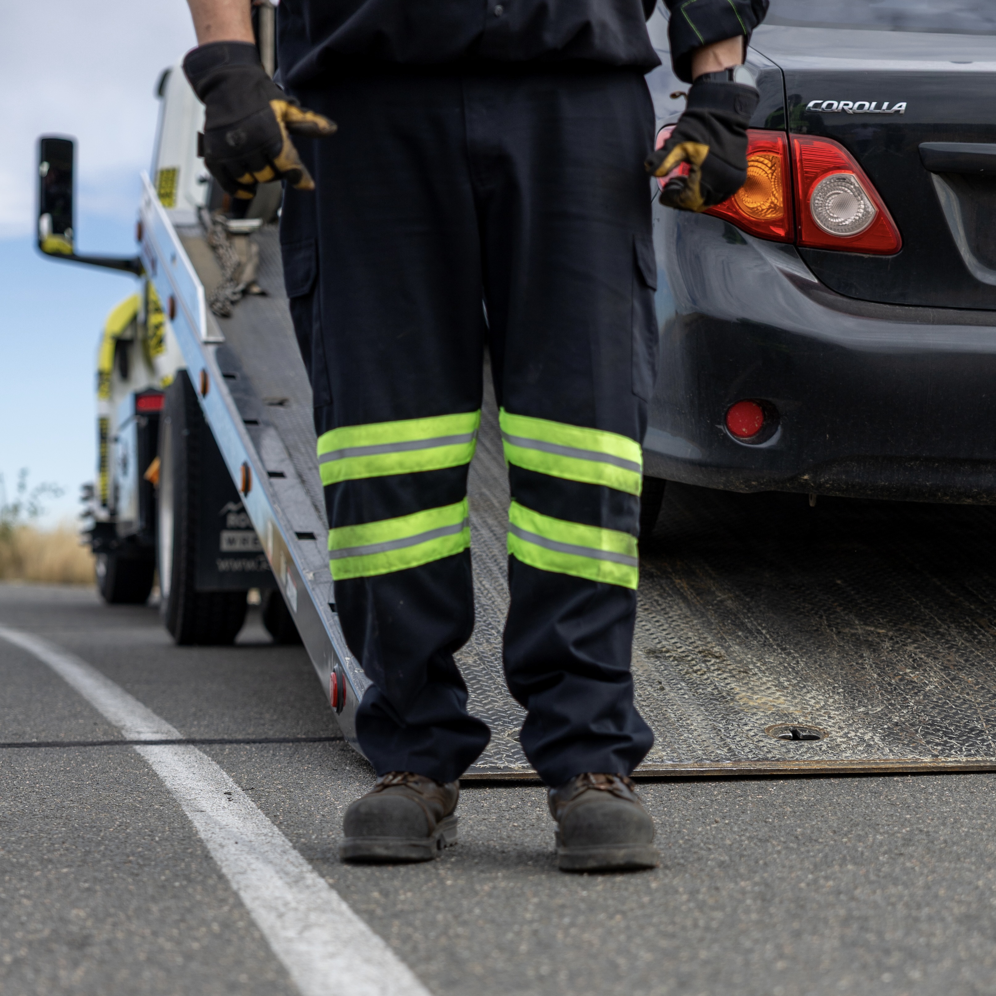 tow truck driver next to white line