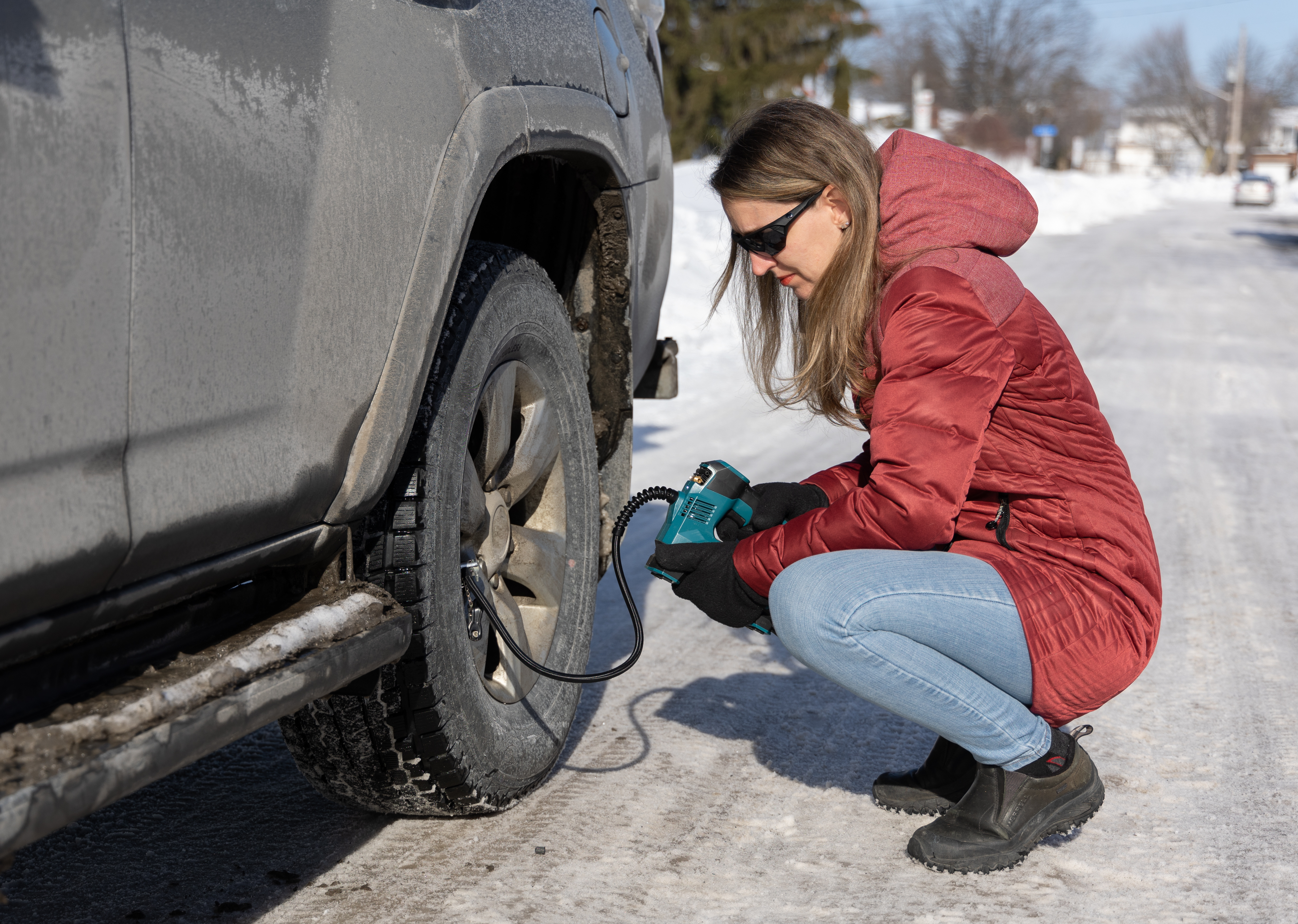 woman checking tire pressure